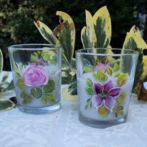 Two small hand painted floral votives and candles
